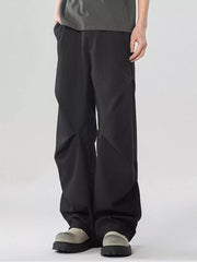 Black oversized wide-leg cargo sweatpants with a relaxed fit and modern paneling.