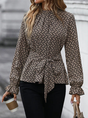 Khaki patterned blouse with tie waist and ruffled flounce sleeves.