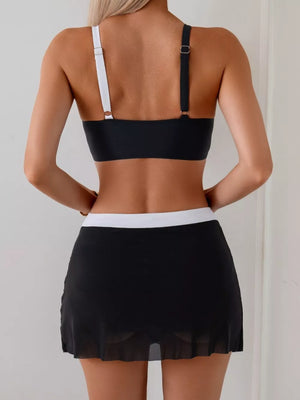 Two-piece black cami bikini with white straps and a black skort with white waistband.
