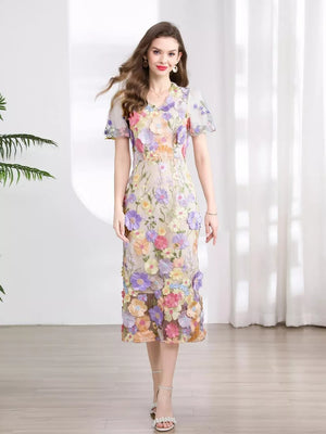 Sheath dress with floral embroidery, short sleeves, V-neck, and midi length.