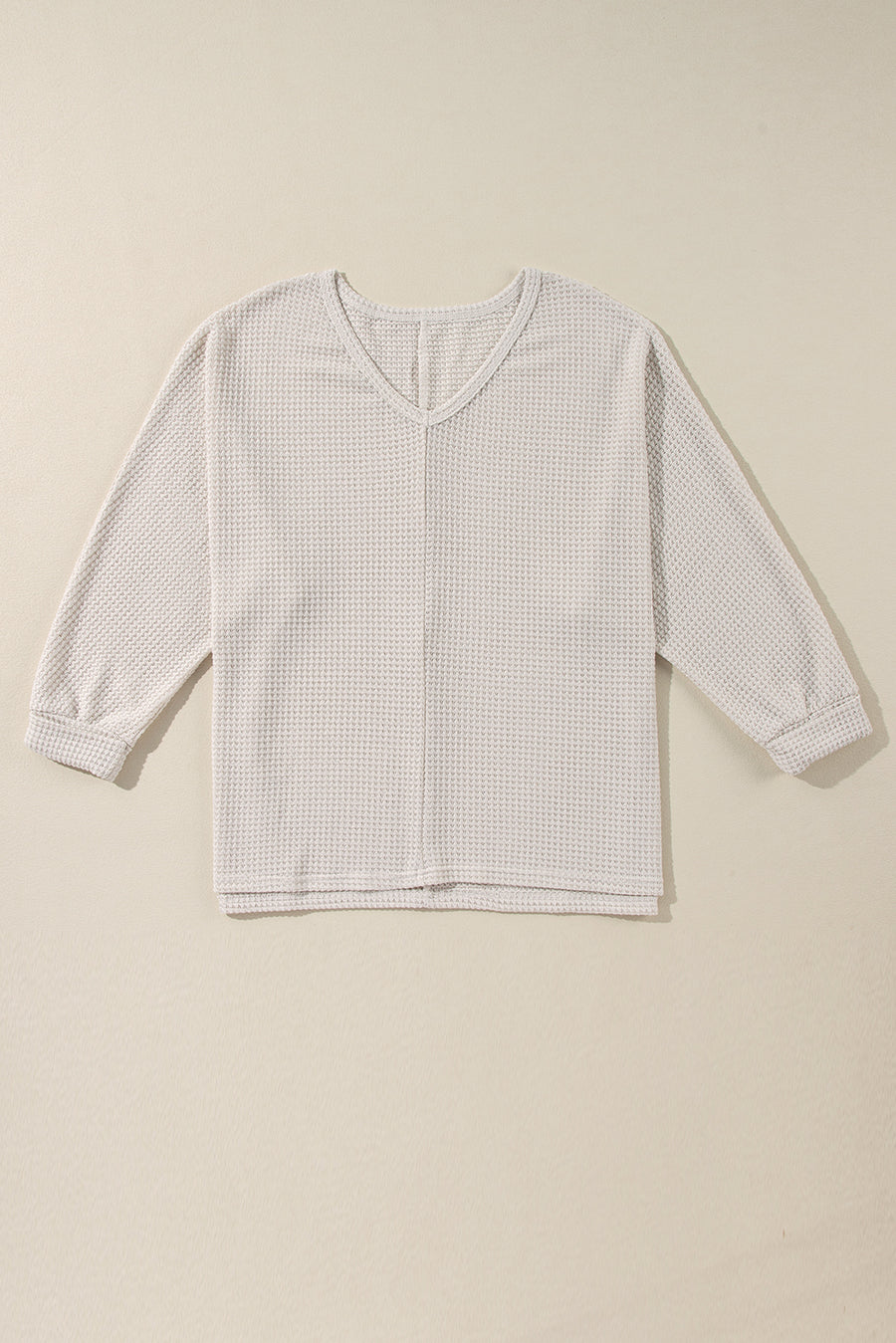 Beige waffle knit v-neck long sleeve top with slit hem detail