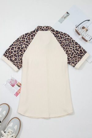 Ribbed cream shirt with leopard print raglan sleeves and collar.