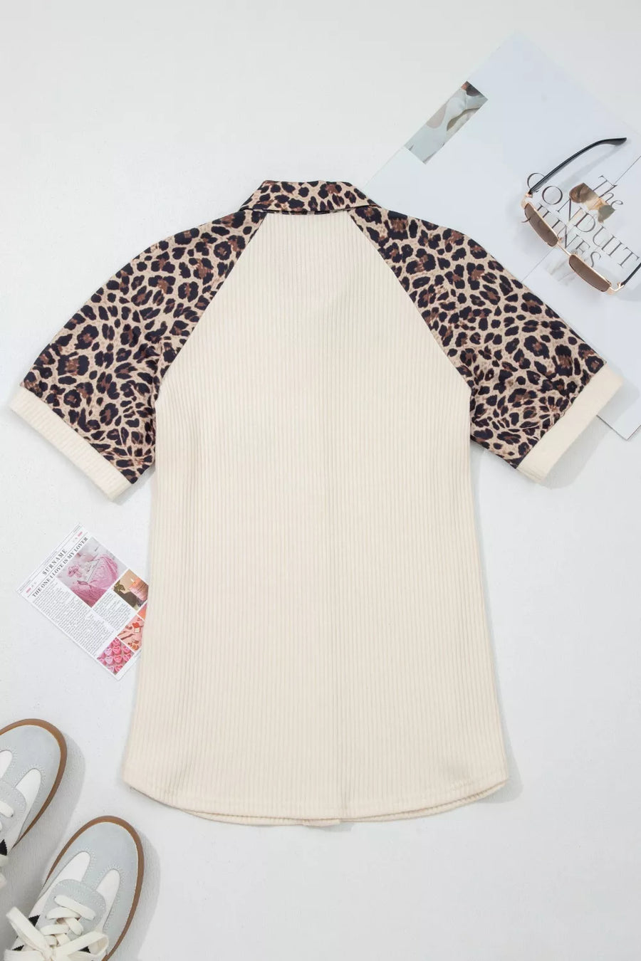Ribbed cream shirt with leopard print raglan sleeves and collar.