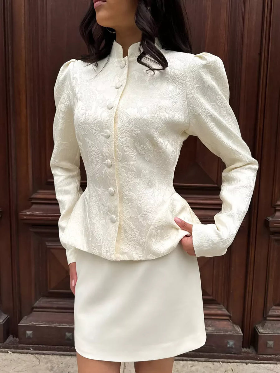 Apricot peplum top featuring buttoned and floral