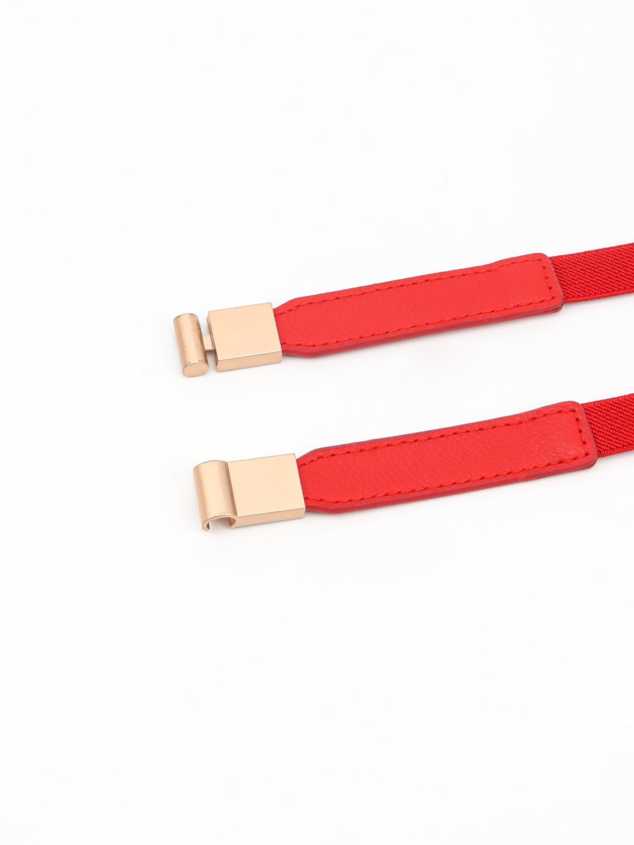 Red elasticated buckle belt with gold-tone hardware and leather detail.