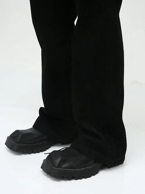 Dark bootcut denim trousers with a classic fit and a subtle flare.