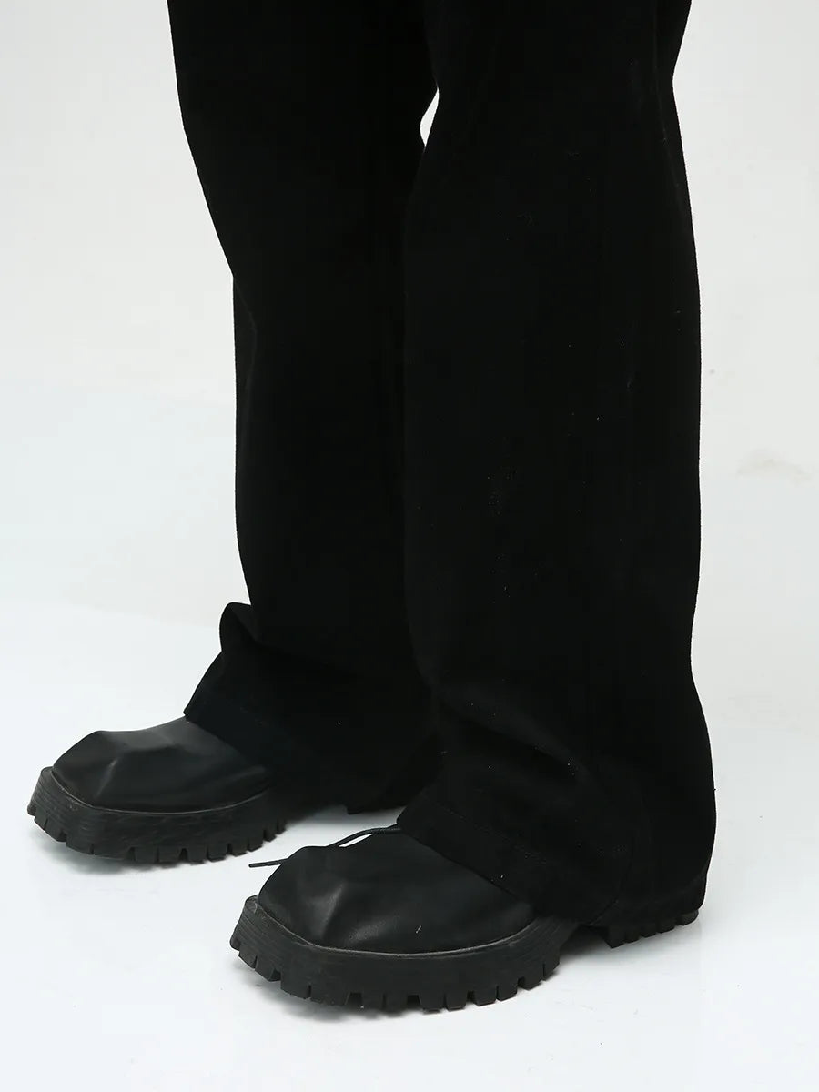 Dark bootcut denim trousers with a classic fit and a subtle flare.