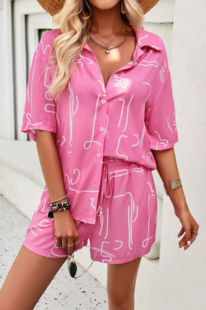 Pink abstract print resort shirt with button-down front and shorts with drawstring waist.