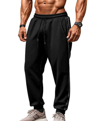 Black athletic joggers with double stripe detail on the side.