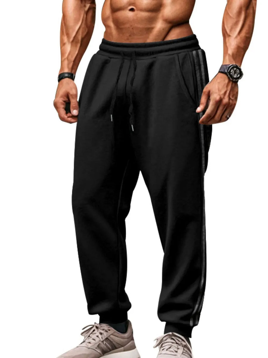 Black athletic joggers with double stripe detail on the side.