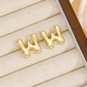 Alphabetical sculpted stud earrings in gold tone, Style W, with bubble design.