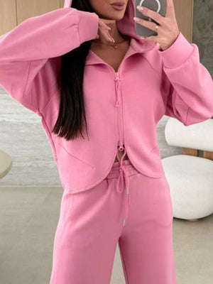 Dusty pink relaxed fit zip-up hoodie and drawstring pants set with a cropped hem detail.