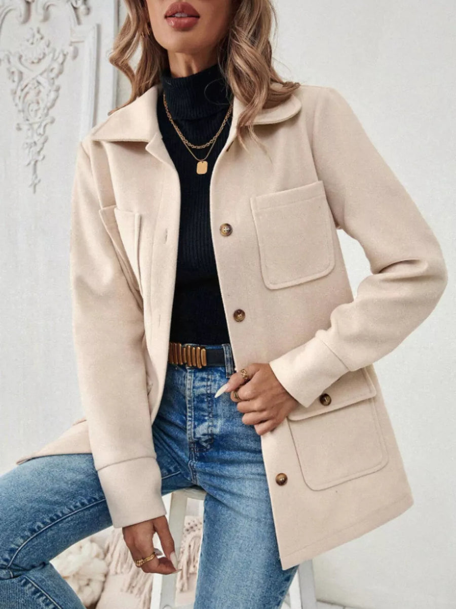 Chic apricot button-front trench coat with two chest pockets and buttoned cuffs.
