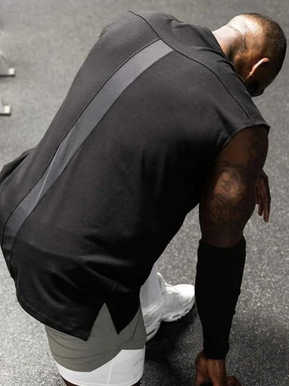 Black performance cut sleeveless tee with a grey stripe detail.