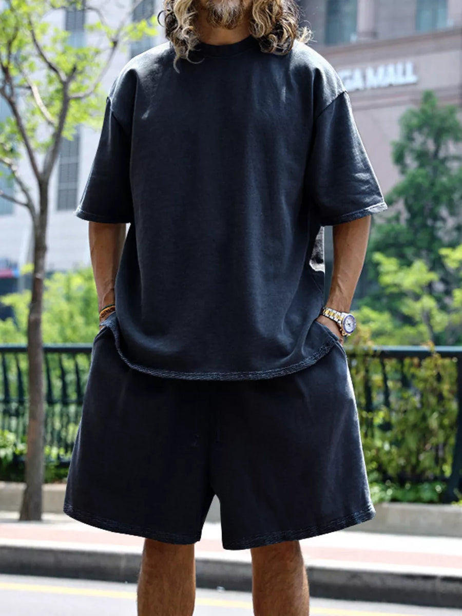 Men's dark gray relaxed fit two-piece set with drawstring shorts and crew neck tee.