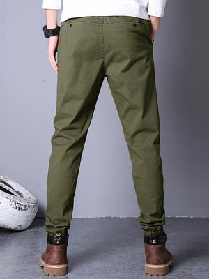 Olive green cotton cargo pants with elastic cuffs and black trim.