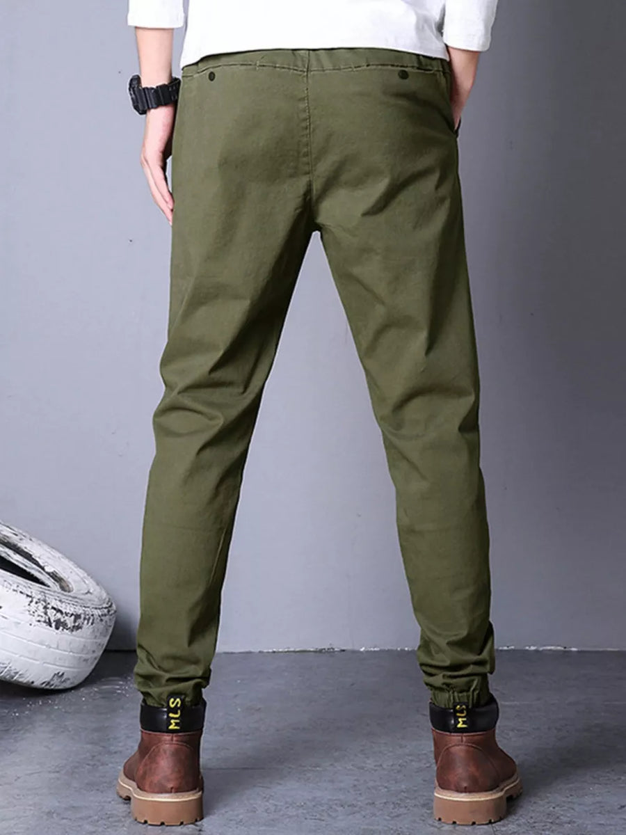 Olive green cotton cargo pants with elastic cuffs and black trim.