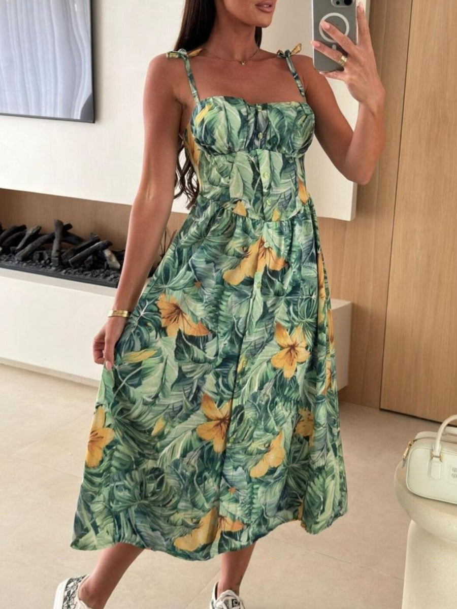 Tie-shoulder midi dress in green tropical print with yellow flowers, square neckline, and button front.