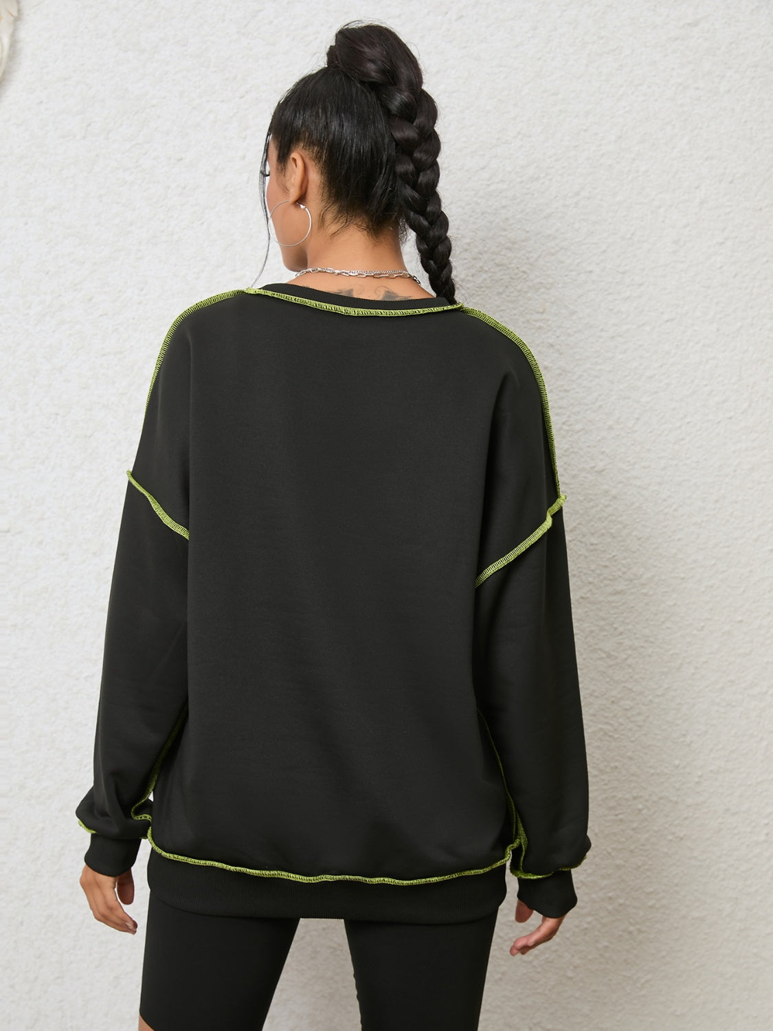 Black sweatshirt with contrast neon stitching, crew neck, long sleeves, casual style
