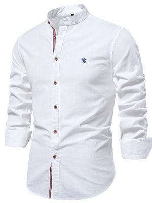 White linen shirt with mandarin collar, buttoned front, and blue embroidered detail.