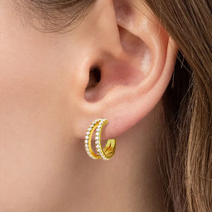 Gold double band hoop earrings with moissanite stones on a model's ear
