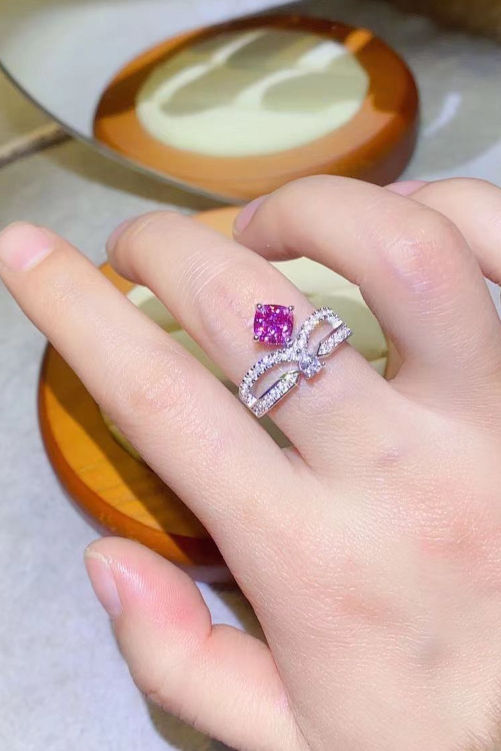 Pink moissanite bow ring in sterling silver with pavé detail