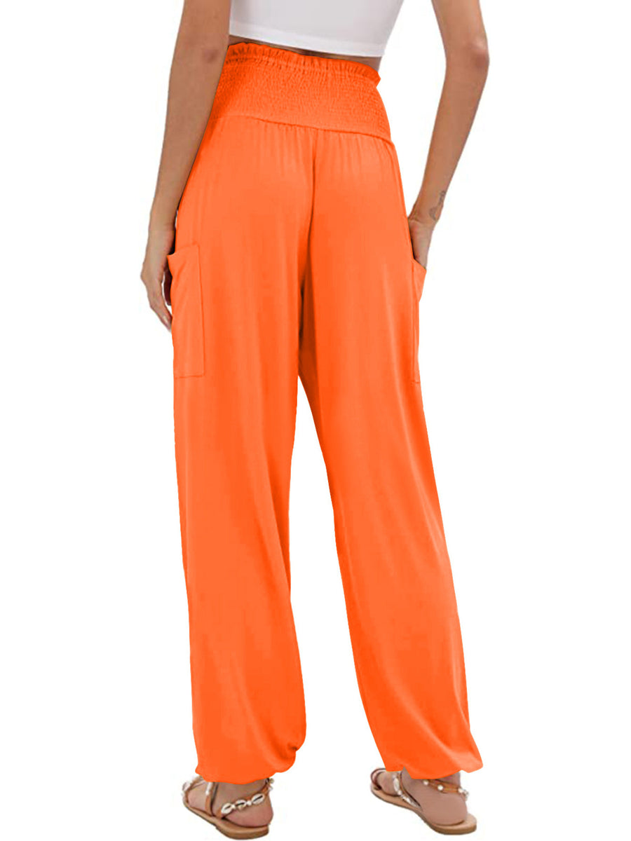 Orange smocked waist harem pants with pockets and ankle cuffs.
