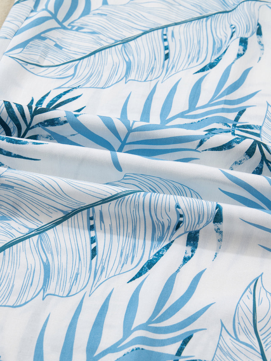 Tropical leaf print wide leg pants in blue and white cotton fabric.