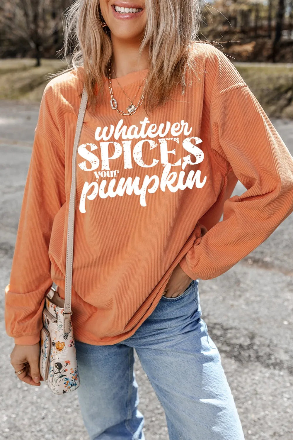 Textured graphic crewneck pullover in sherbet orange with "whatever SPICES your pumpkin" graphic.
