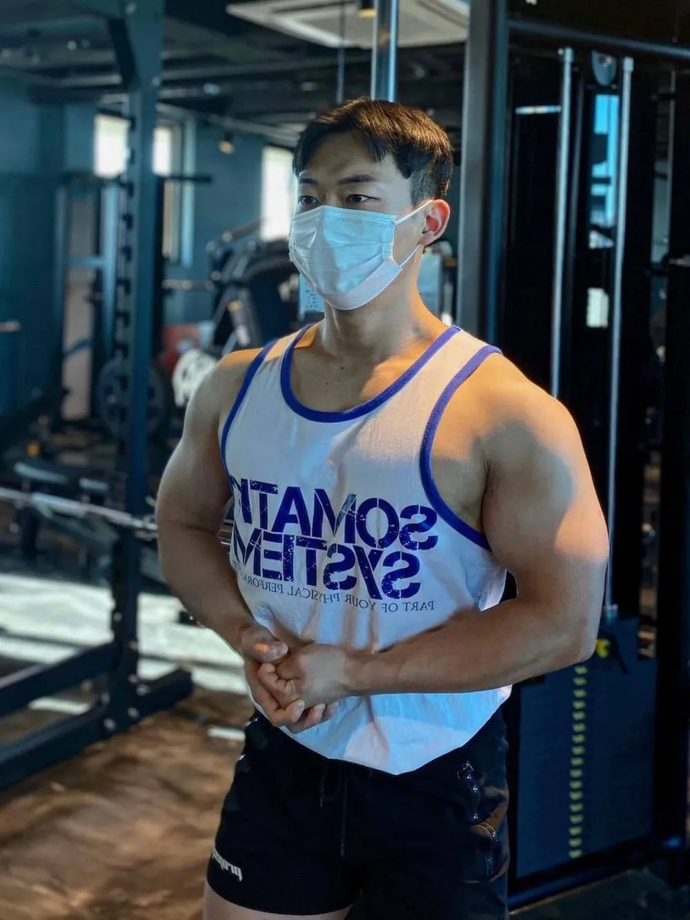 White tank top with blue trim and reversed graphic print, athletic fit