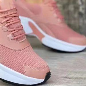 Pink lace up air cushion sneakers with white soles and chunky soles.