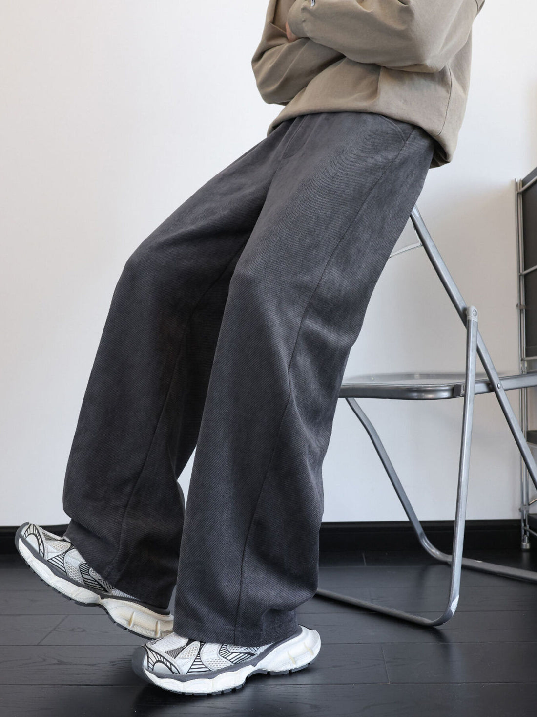 Men's gray wide-leg sweatpants with pockets and a textured fabric.