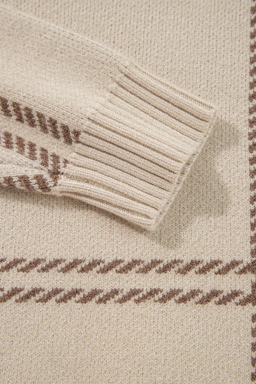 Tan knit crewneck pullover with brown gridline pattern and ribbed cuffs.
