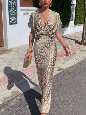 Twist-front animal print maxi dress with deep V-neck and short sleeves.