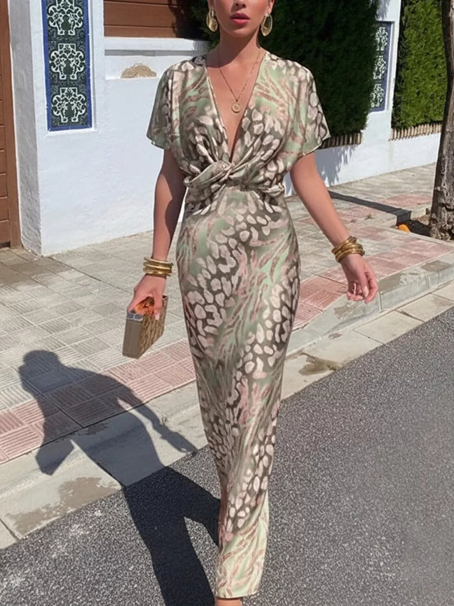 Twist-front animal print maxi dress with deep V-neck and short sleeves.