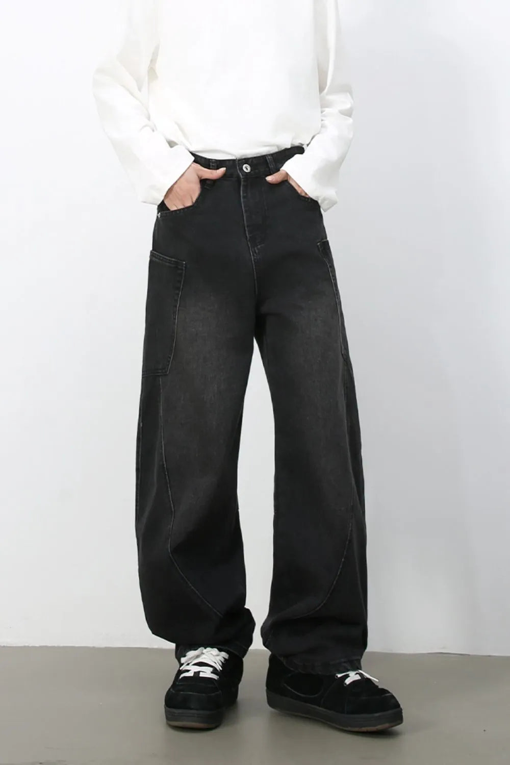 Black denim baggy trousers with a wide leg and pocket details.