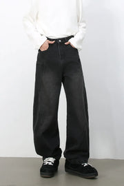 Black denim baggy trousers with a wide leg and pocket details.