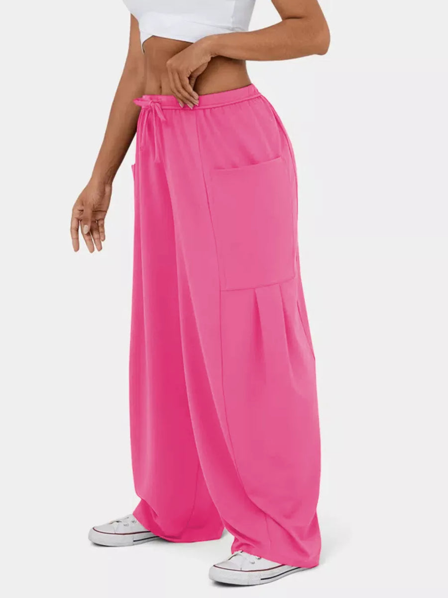 Rose Red maternity pants with adjustable drawstring, wide legs, and pleated cargo pockets.