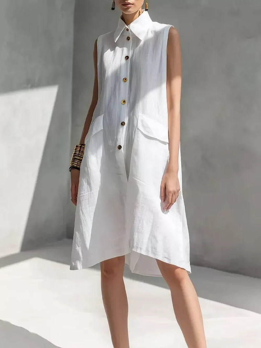 White linen sleeveless collared shirt dress with button front and flap pockets