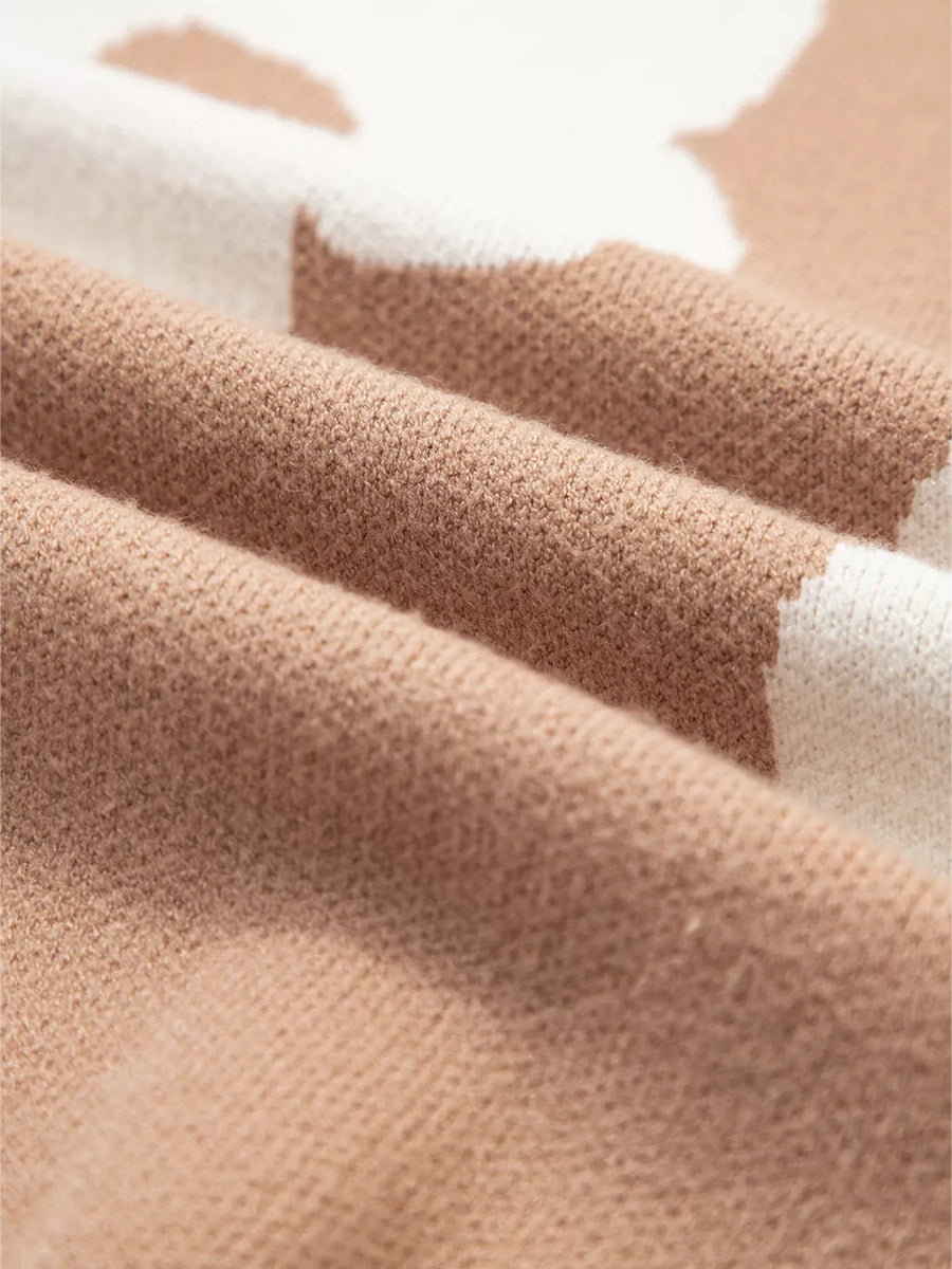 Tan floral pattern baggy sweater with a soft knit texture.