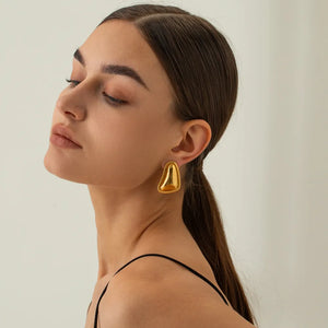 Sculpted gold vermeil earrings with textured edge detail.