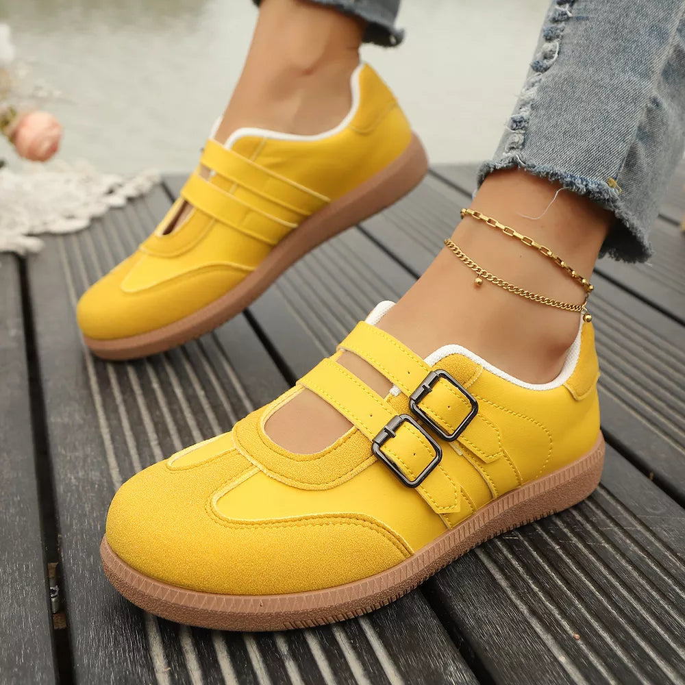 Yellow buckle strap Mary-jane inspired sneakers with double buckle detail and white trim.