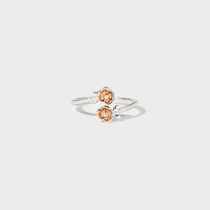 Silver bypass ring with rosebud details and pavé band