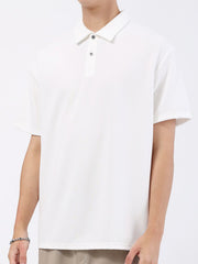 White textured performance polo shirt with short sleeves and a two-button placket.