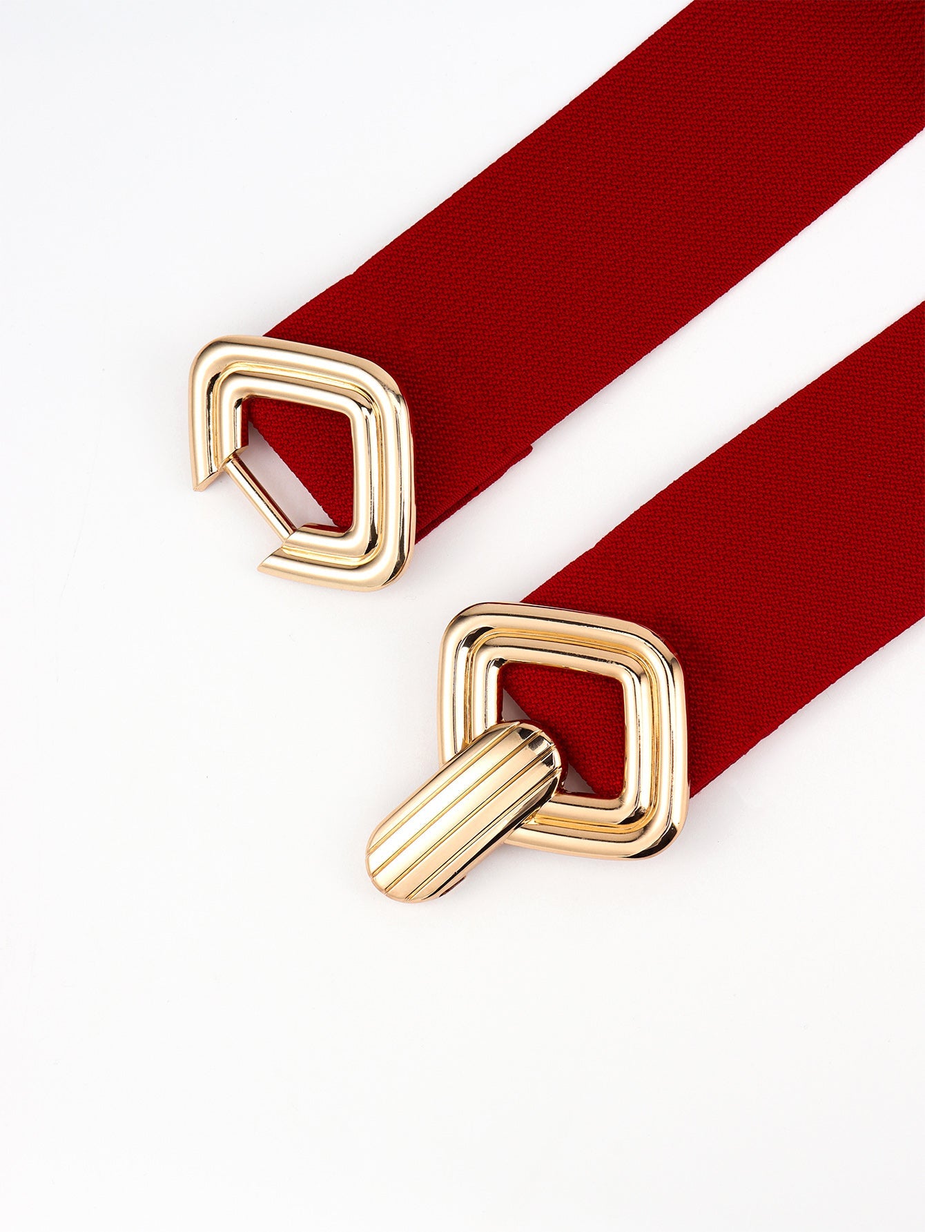 Red elastic belt with gold geometric buckle detail