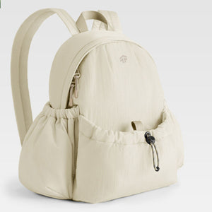 Beige lightweight nylon drawstring backpack with zippered main compartment and cinched side pockets.