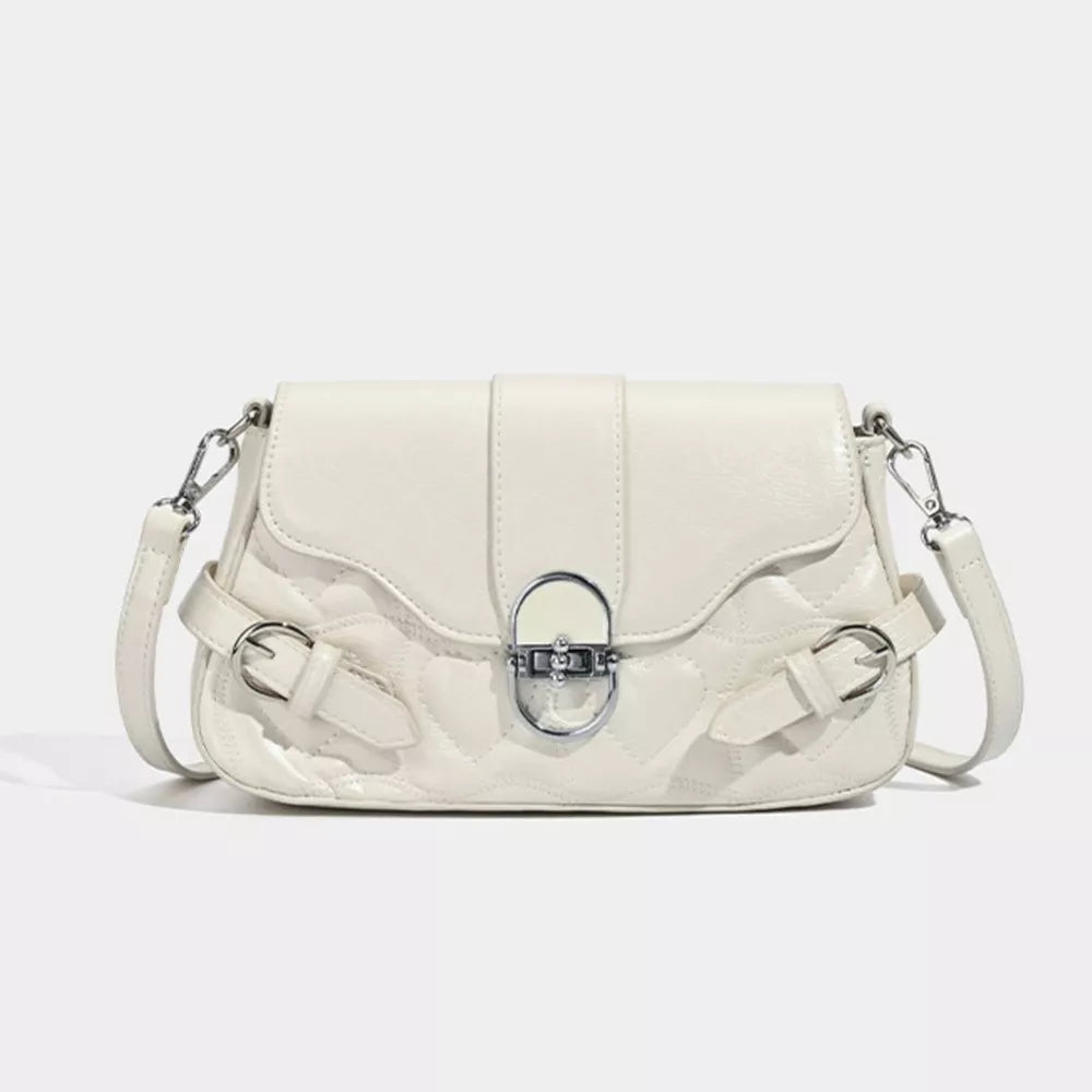 White heart-quilted crossbody bag with buckle accents and silver hardware