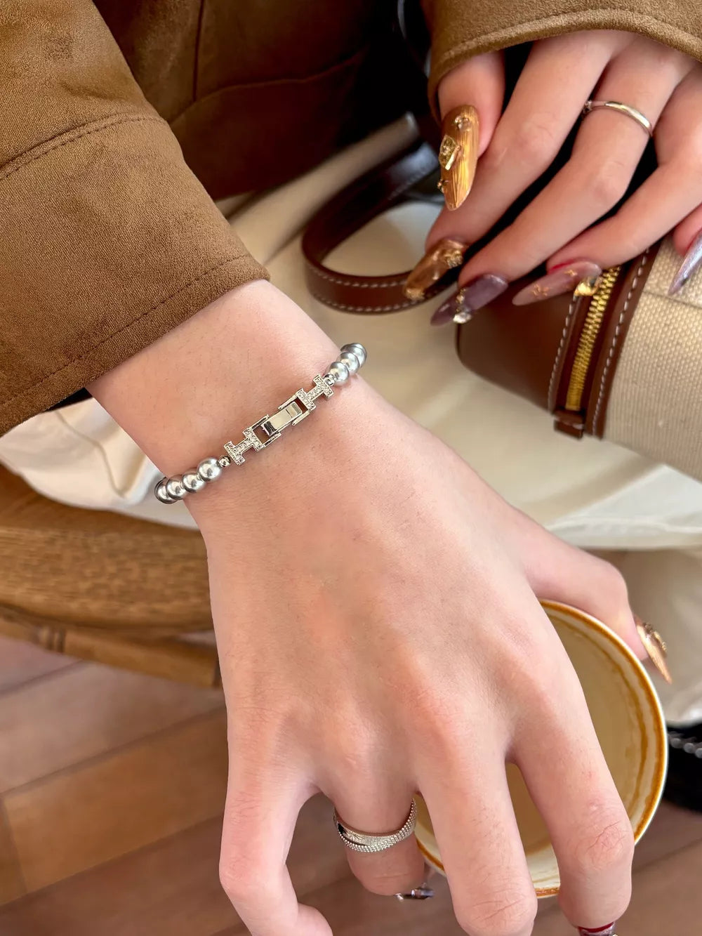 Silver beaded bracelet with pearl buckle and zircon accents