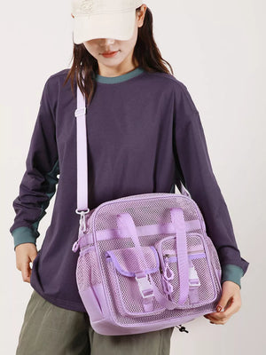 Lavender mesh crossbody bag with unique buckle accents and multiple pockets.