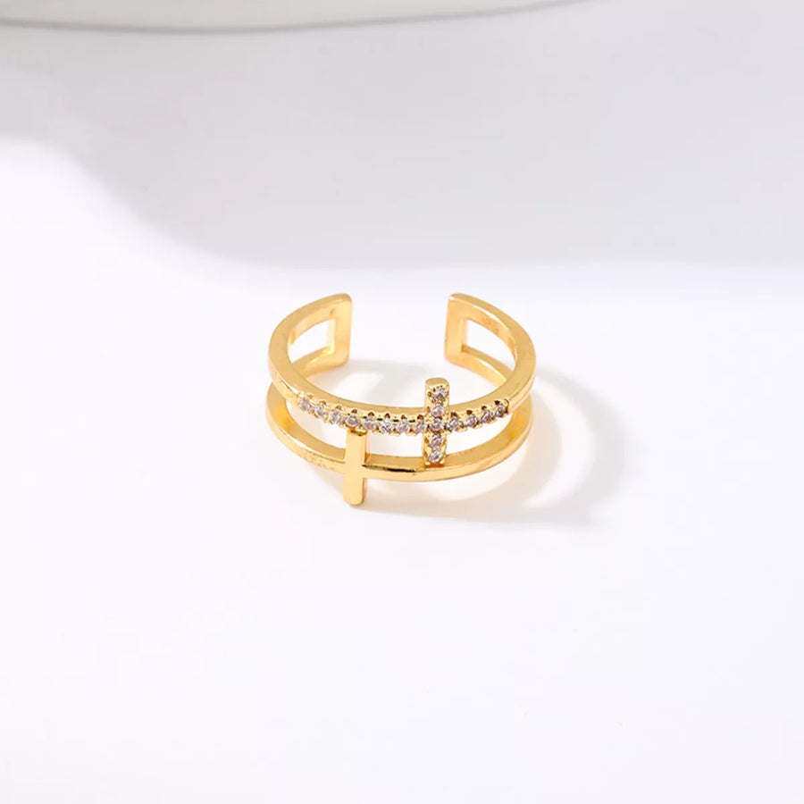 Golden open ring with rhinestone cross detail, 18K gold-plated.
